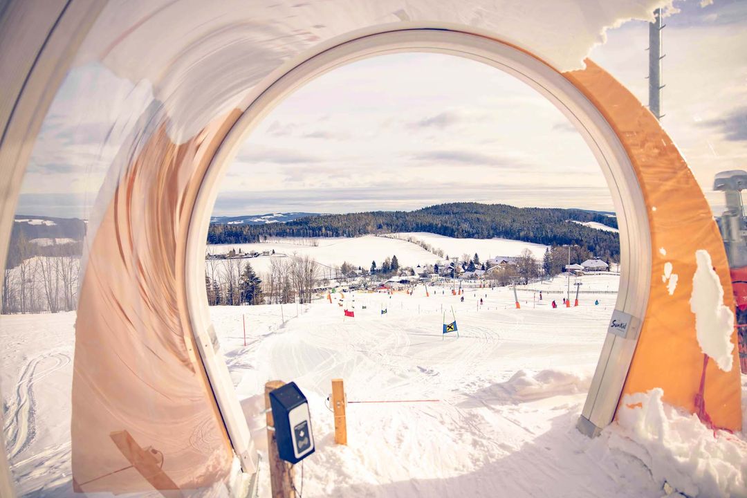 Wexl Arena – St Corona am Wechsel in Austria - a view of a ski area through a window.