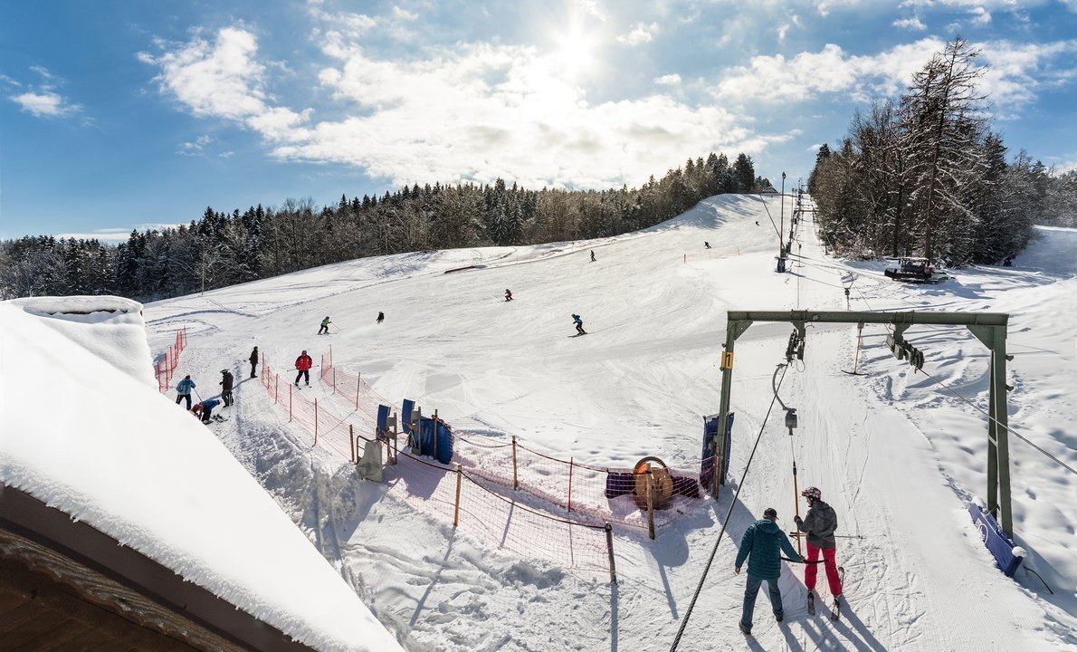 Poseka – Ravne na Koroškem in Slovenia - a group of people skiing down a snowy slope.