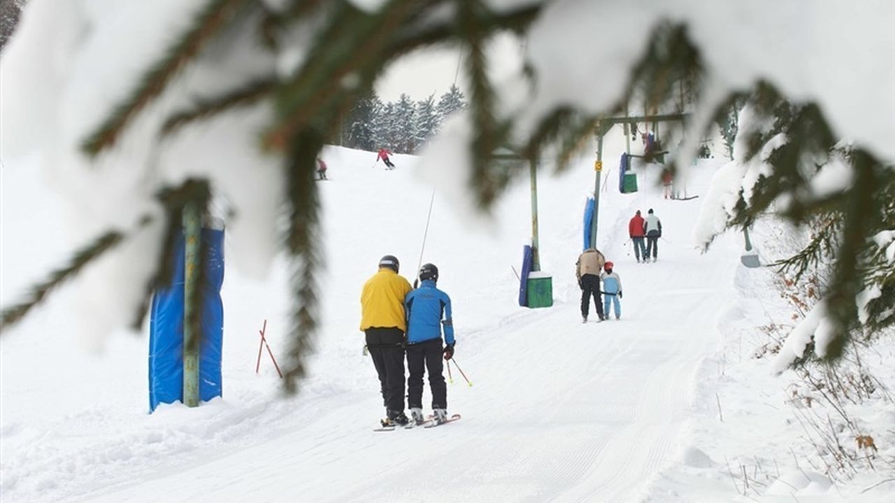 Poseka – Ravne na Koroškem in Slovenia - a group of people skiing down a snowy slope.