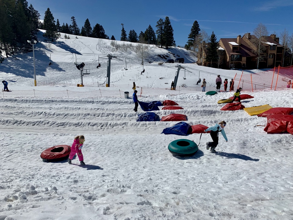 Angel Fire Resort in USA - a group of people skiing down a snowy hill.