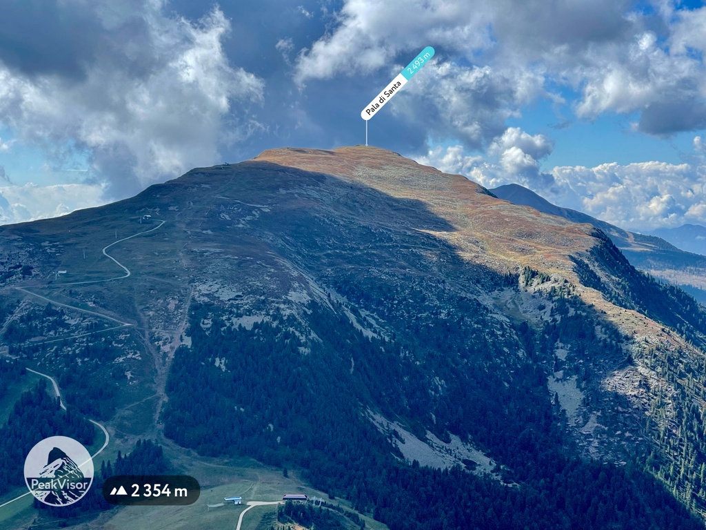 Malga Varena – Passo Lavazè in Italy - a person flying a kite on a mountain.
