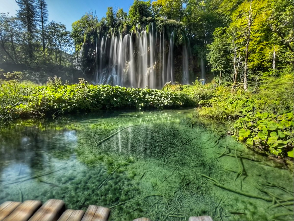 ŠRC Mukinje in Croatia - a large waterfall in the middle of a lake.