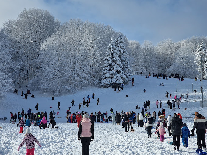 ŠRC Mukinje in Croatia - a group of people walking through a snow covered park.