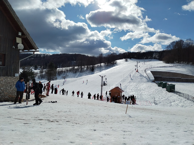 ŠRC Mukinje in Croatia - a group of people standing on a snow covered slope.