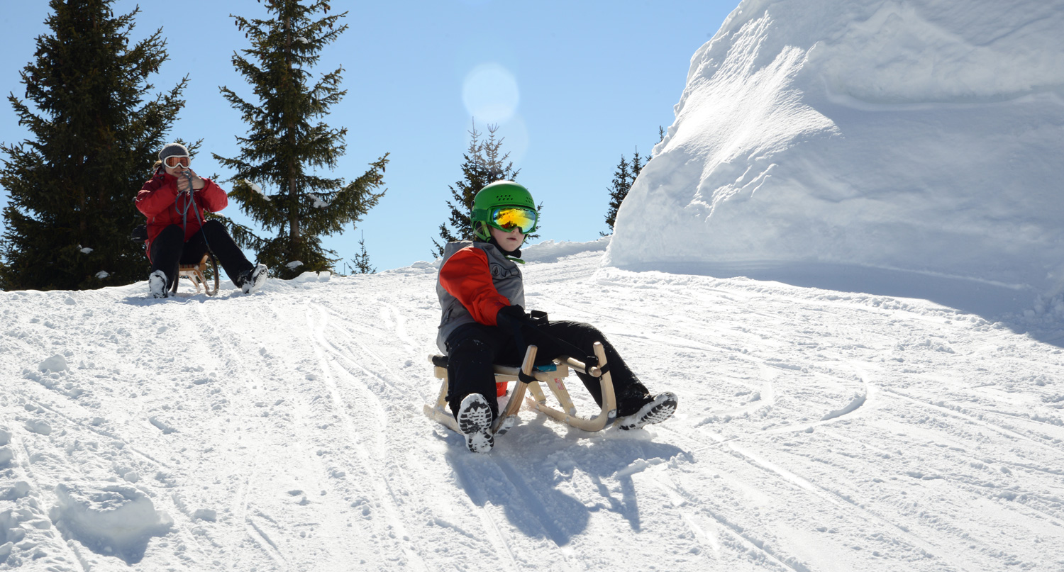 Venet – Landeck | Zams | Fliess in Austria - a group of people riding down a snowy hill.