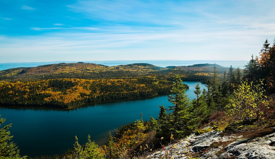 Le Mont Grand-Fonds in Canada - a view from the top of a mountain with a lake in the distance.