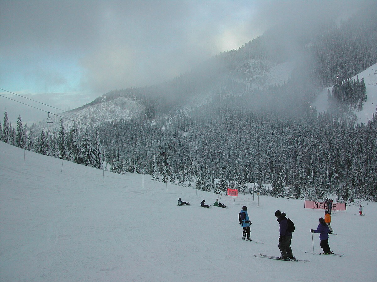 Cypress Mountain in Canada - a group of people skiing down a snowy slope.