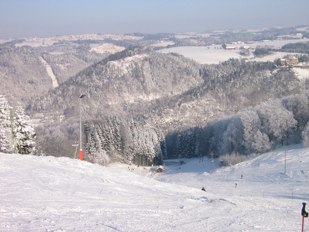 Brandtner Lifte – Hartkirchen in Austria - a group of people skiing down a snowy hill.