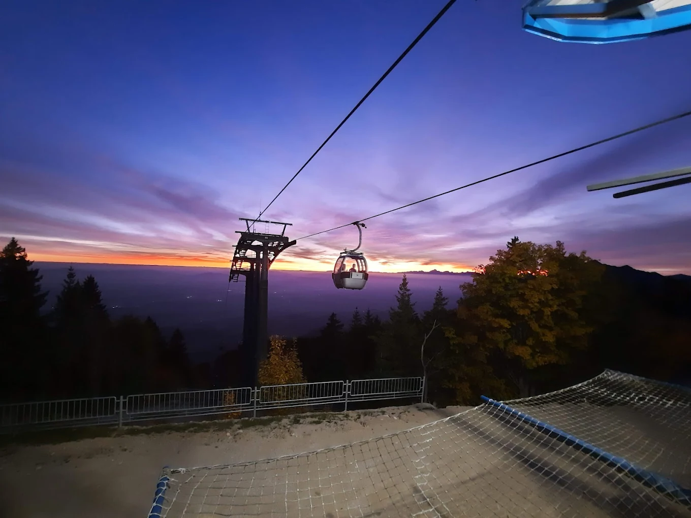 Krvavec in Slovenia - a ski lift going up the mountain at sunset.