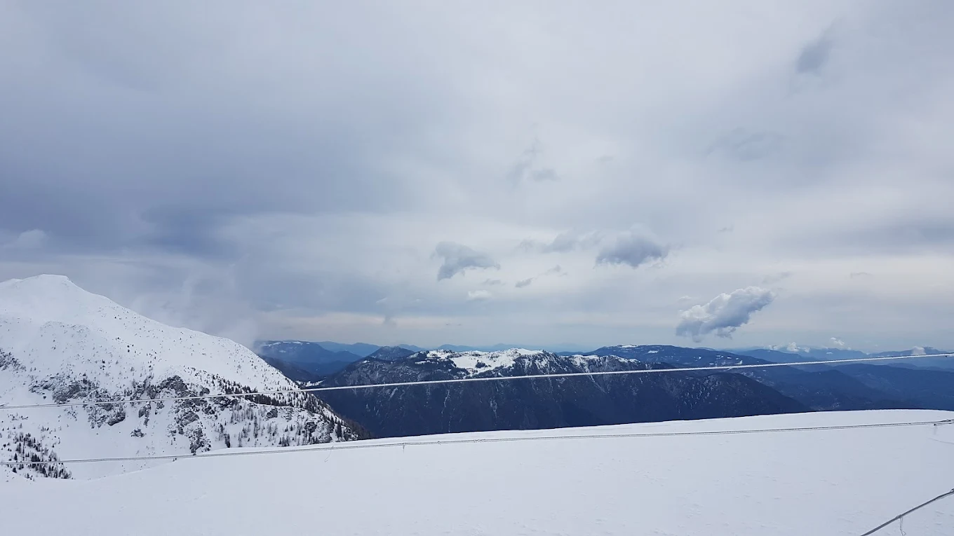 Krvavec in Slovenia - a view from the top of a snowy mountain.