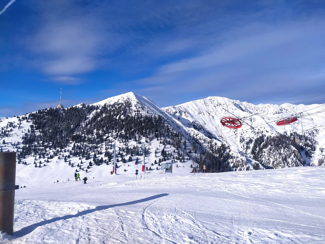 Krvavec in Slovenia - a ski lift going up a snowy mountain.