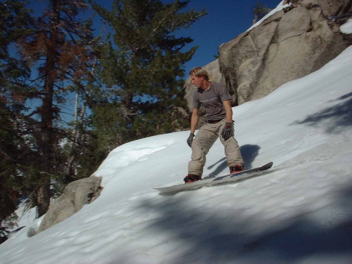 Buckhorn Ski and Snowboard Club in USA - a man riding a snowboard down a snow covered slope.