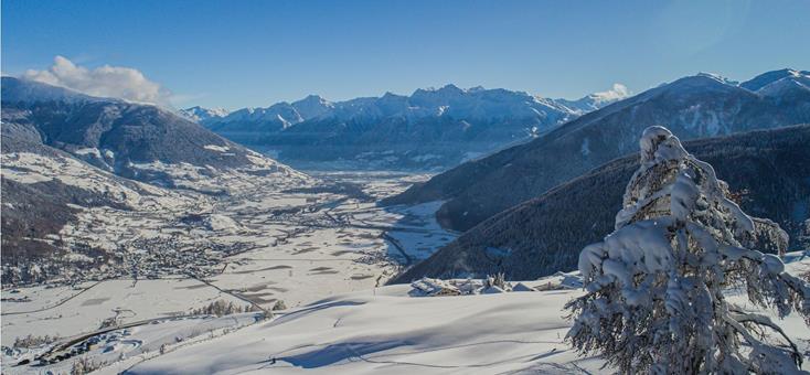 Image of a charming chalet amidst a stunning winter scenery at the Watles-Malles Venosta ski resort in South Tyrol Italy. The scene captures the ambiance of winter sports activities.
