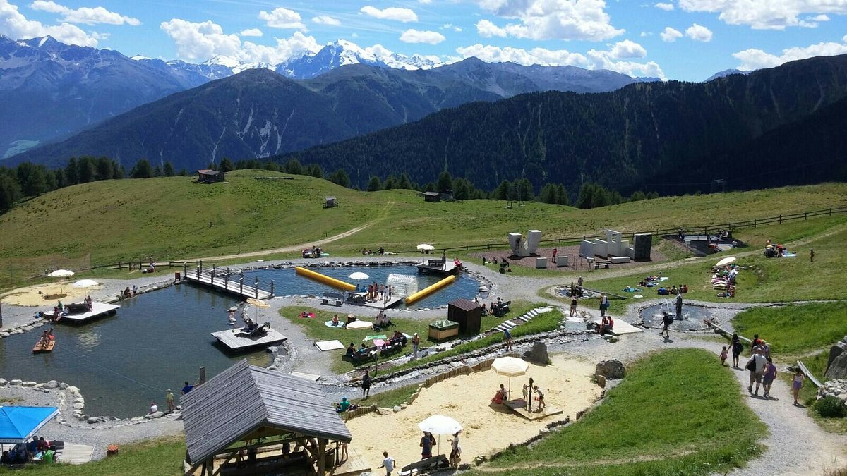 Watles – Malles Venosta in Italy - a group of people standing on top of a mountain.