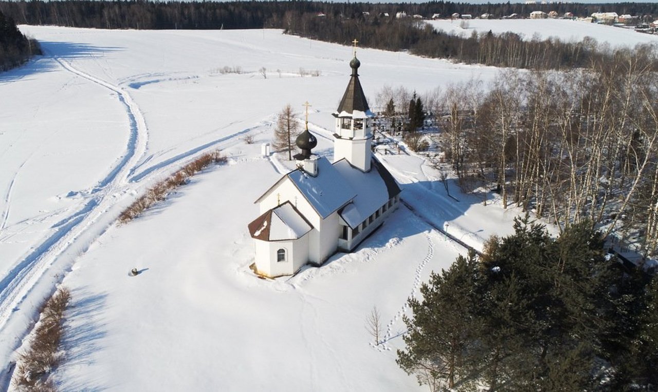 Sports complex "Podolino" in Russia - a church in the middle of a snow covered field.