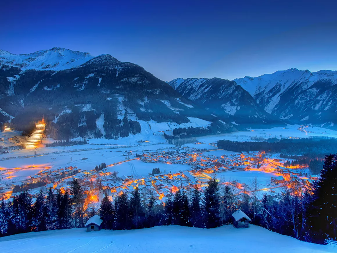 Neukirchen in Germany - a snowy town in the mountains at night.