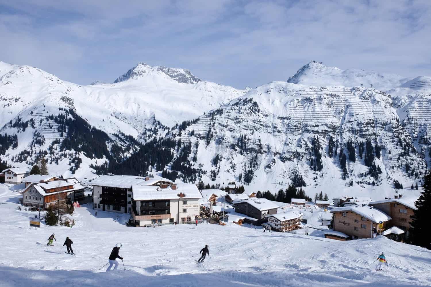 Spitzingsee-Tegernsee in Germany - a group of people skiing down a snowy slope.