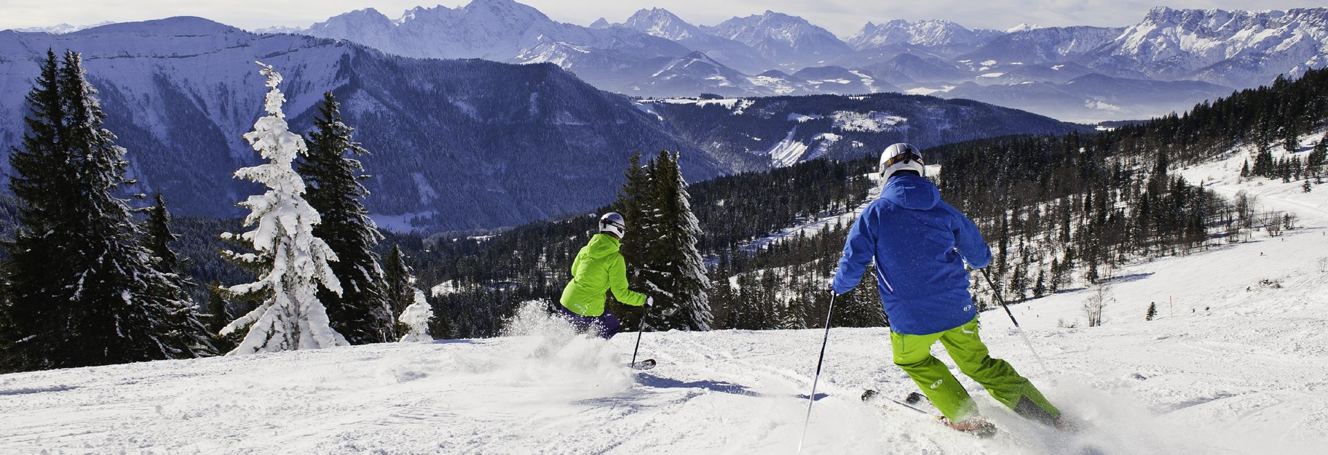 Krispl in Austria - two people are skiing down a snowy slope.