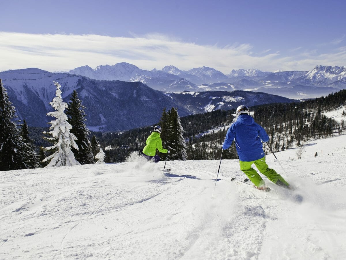 Krispl in Austria - two skiers skiing down a snowy slope.