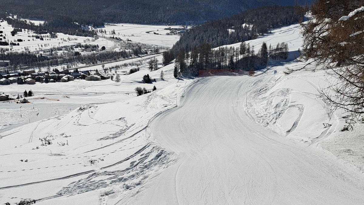 Survih – Samedan in Switzerland - a view of a snow covered ski slope.