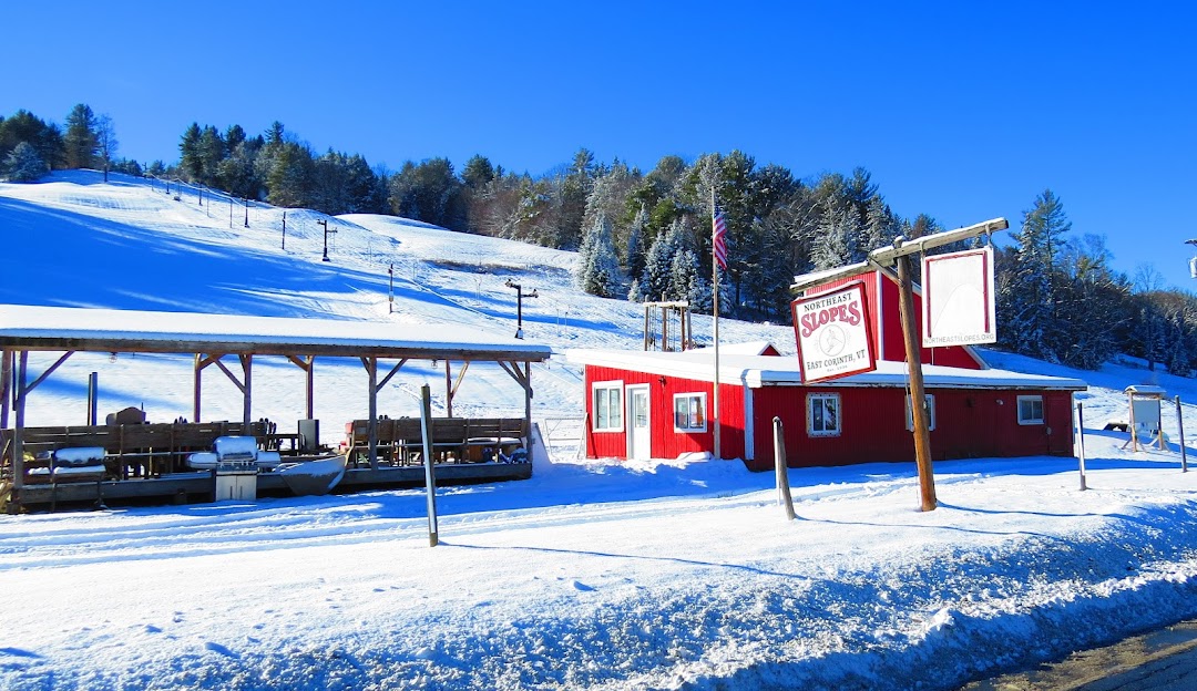 View of Northeast Slopes in East Corinth featuring its ski resort and winter sports centre. Visible are the ski lift and lodge amidst a captivating winter sports scene.