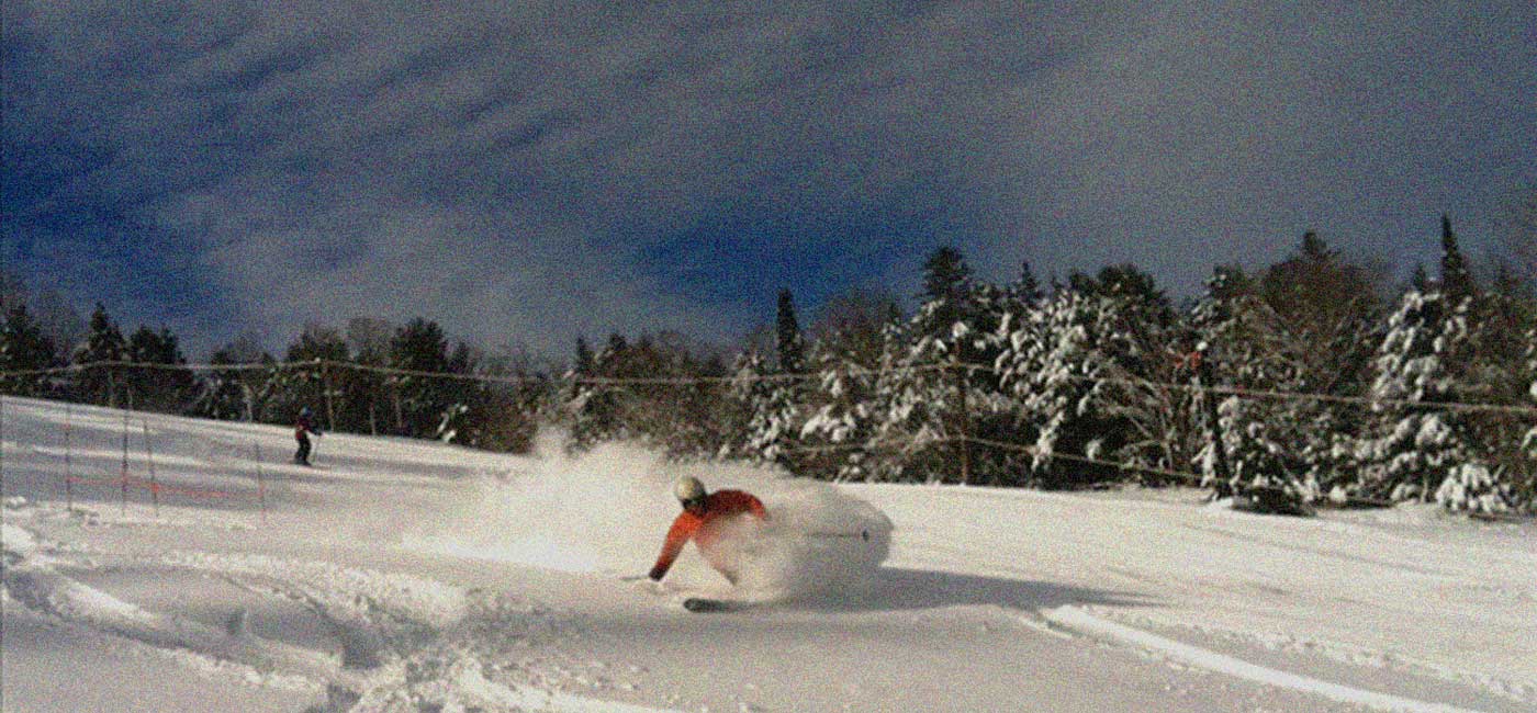 Northeast Slopes – East Corinth in USA - a person riding a snowboard down a slope.