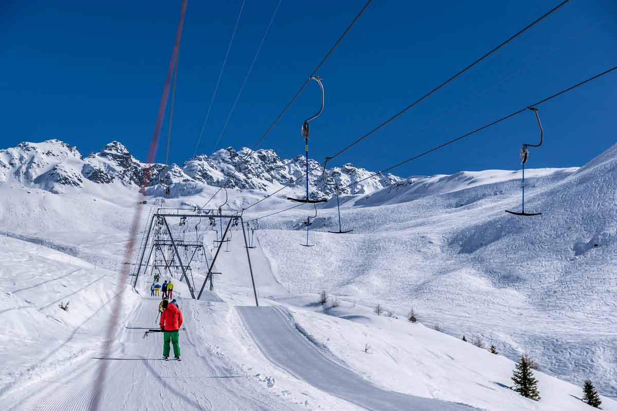 Rinerhorn in Switzerland - a person riding a ski lift in the snow.