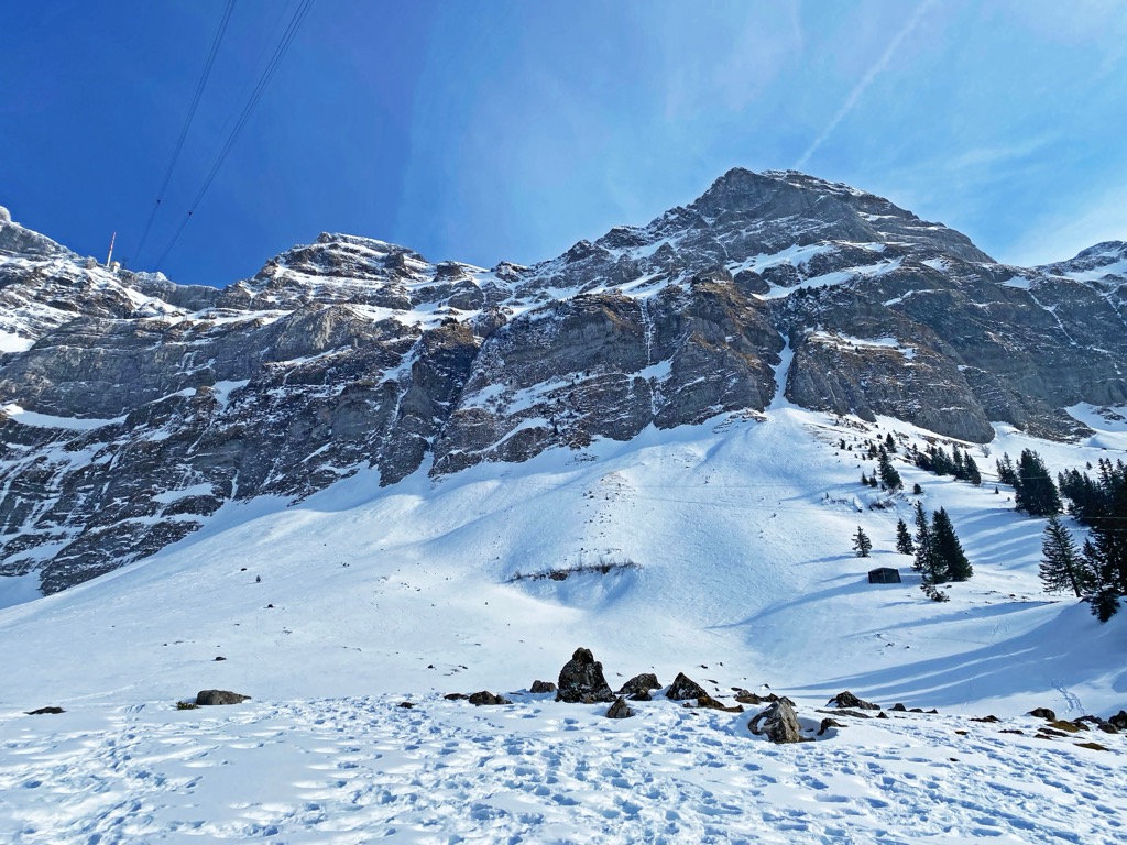 Urnäsch – Osteregg in Switzerland - a snow covered mountain with a ski lift in the background.