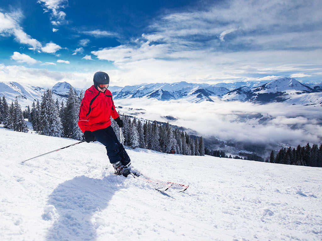 Kirchdorf in Austria - a person skiing down a snowy mountain.