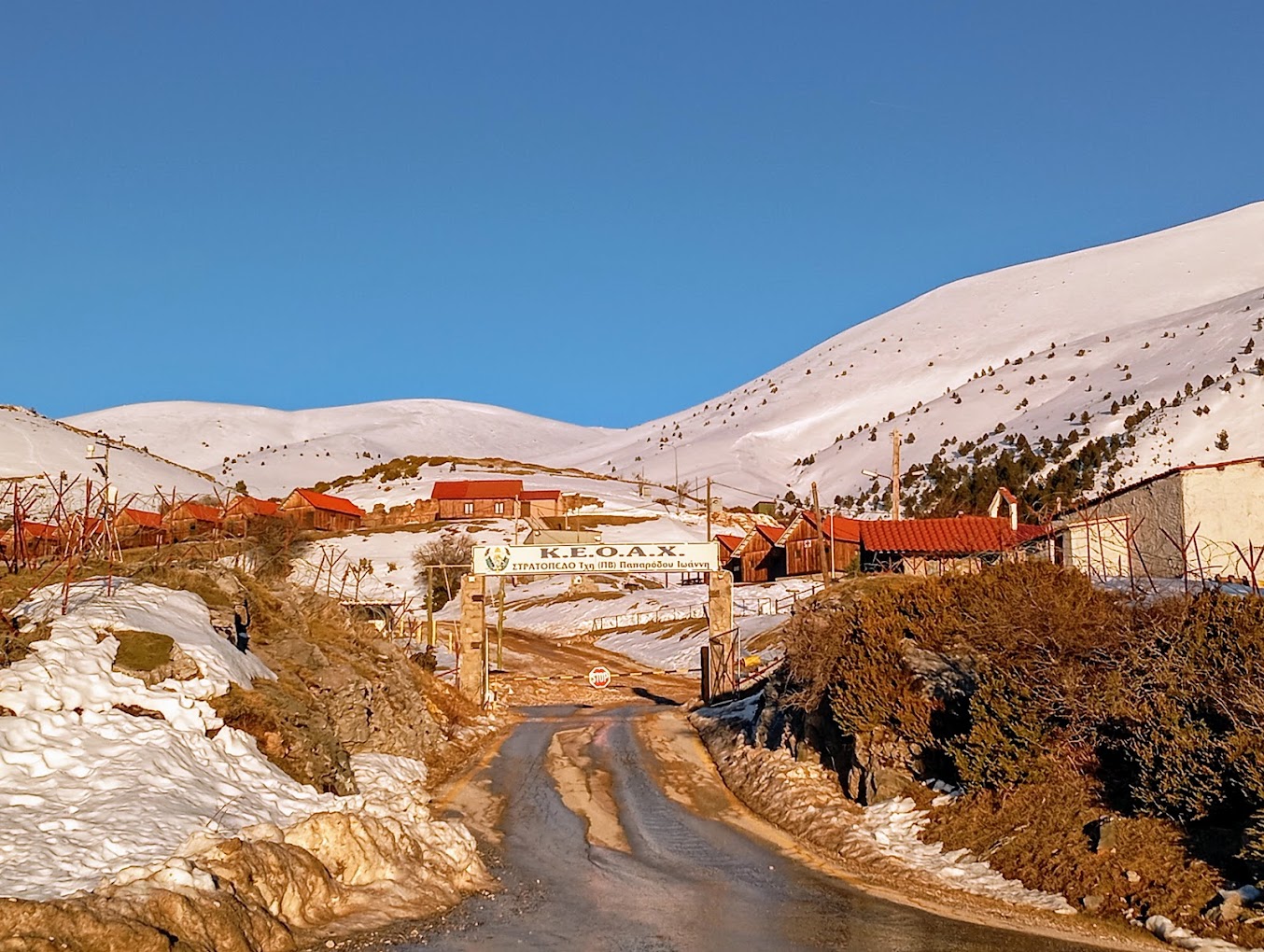 Olympus – Vryssopoules in Greece - a road in the middle of a snowy town.