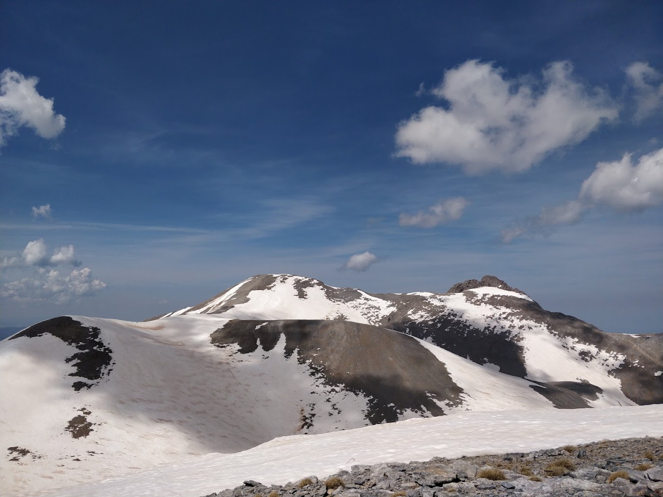 Olympus – Vryssopoules in Greece - a snow covered mountain with a few clouds.