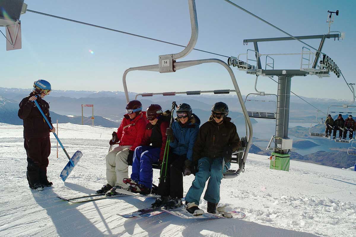 Treble Cone in New Zealand - a group of people standing on a ski slope.