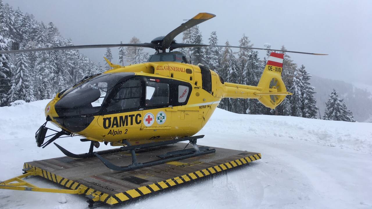 Brandlwiese – Kaumberg in Austria - a yellow helicopter sitting on top of snow covered ground.