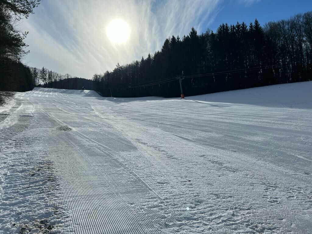 Brandlwiese – Kaumberg in Austria - a snow covered ski slope with trees in the background.