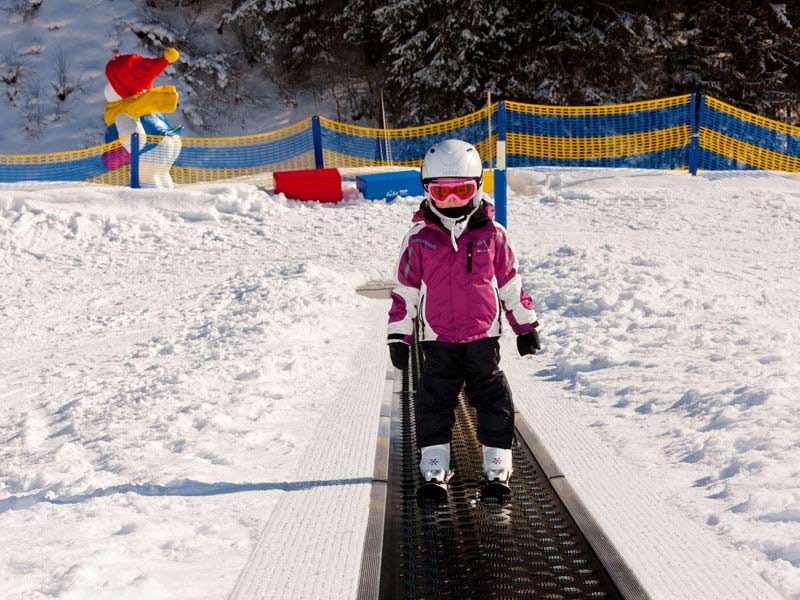 Sonnenberglift – Gries im Sellrain in Austria - a little girl on a snowboard in the snow.
