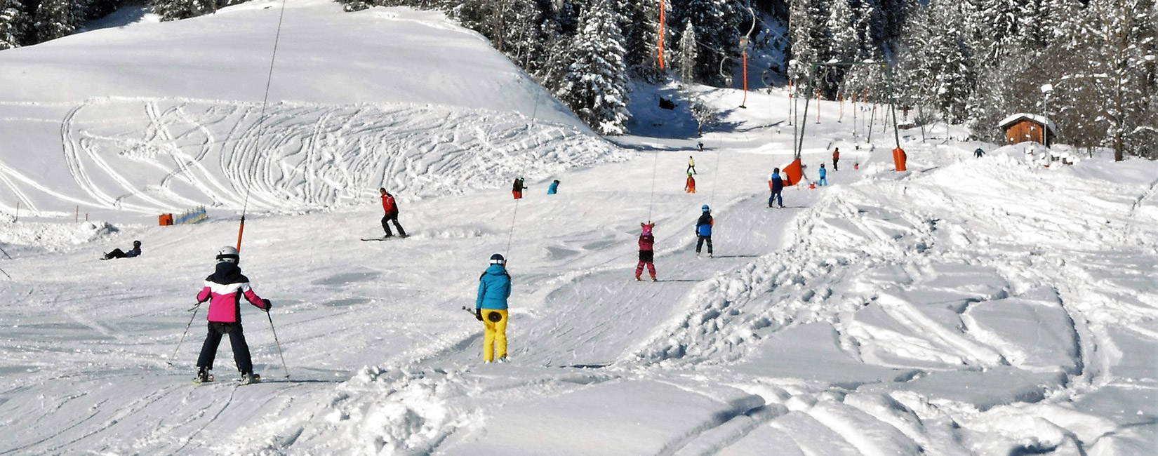 Sonnenberglift – Gries im Sellrain in Austria - a group of people skiing down a snowy slope.