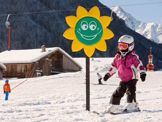 Sonnenberglift – Gries im Sellrain in Austria - a young girl is skiing down the slope.