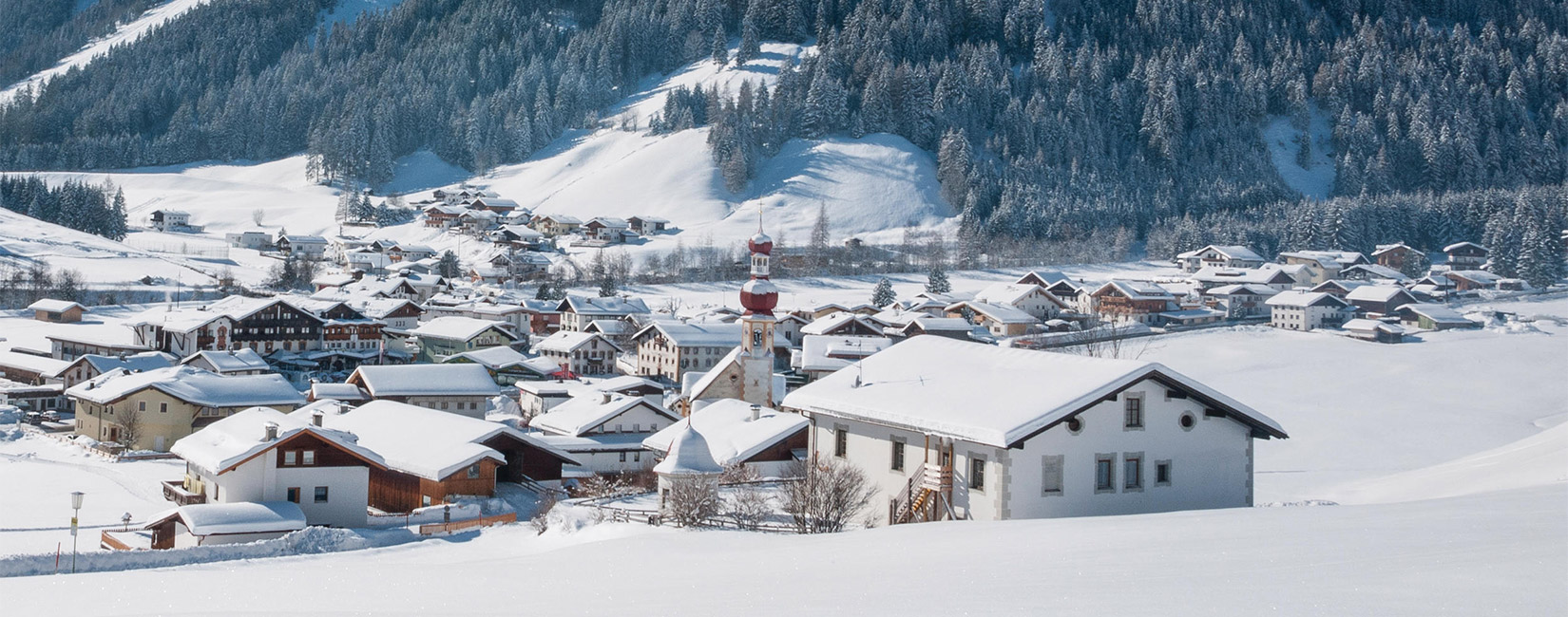Sonnenberglift – Gries im Sellrain in Austria - a small town covered in snow in the mountains.