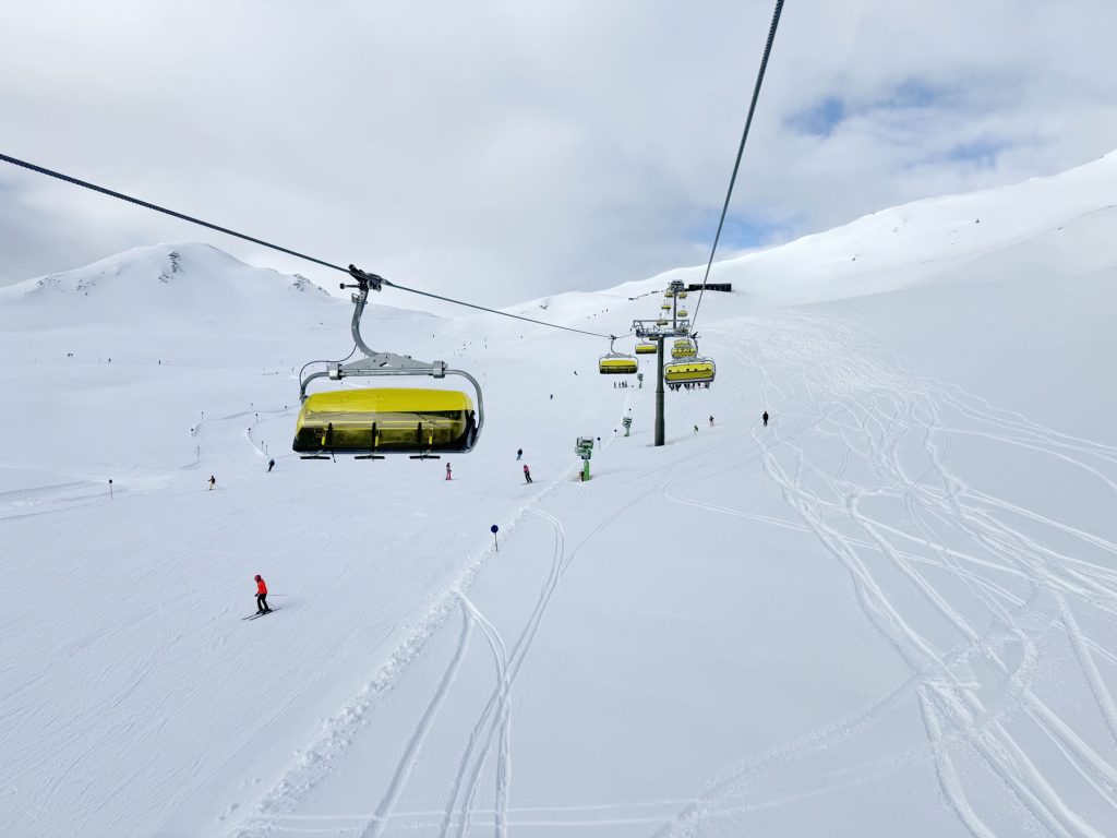 Wildkogel in Austria - a ski lift going up a snowy slope.