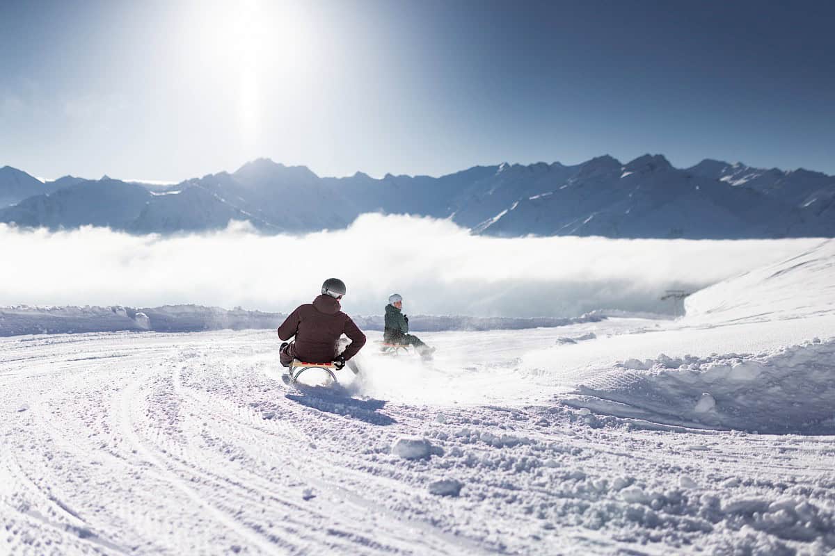 Wildkogel in Austria - a man riding a snowboard down a mountain.