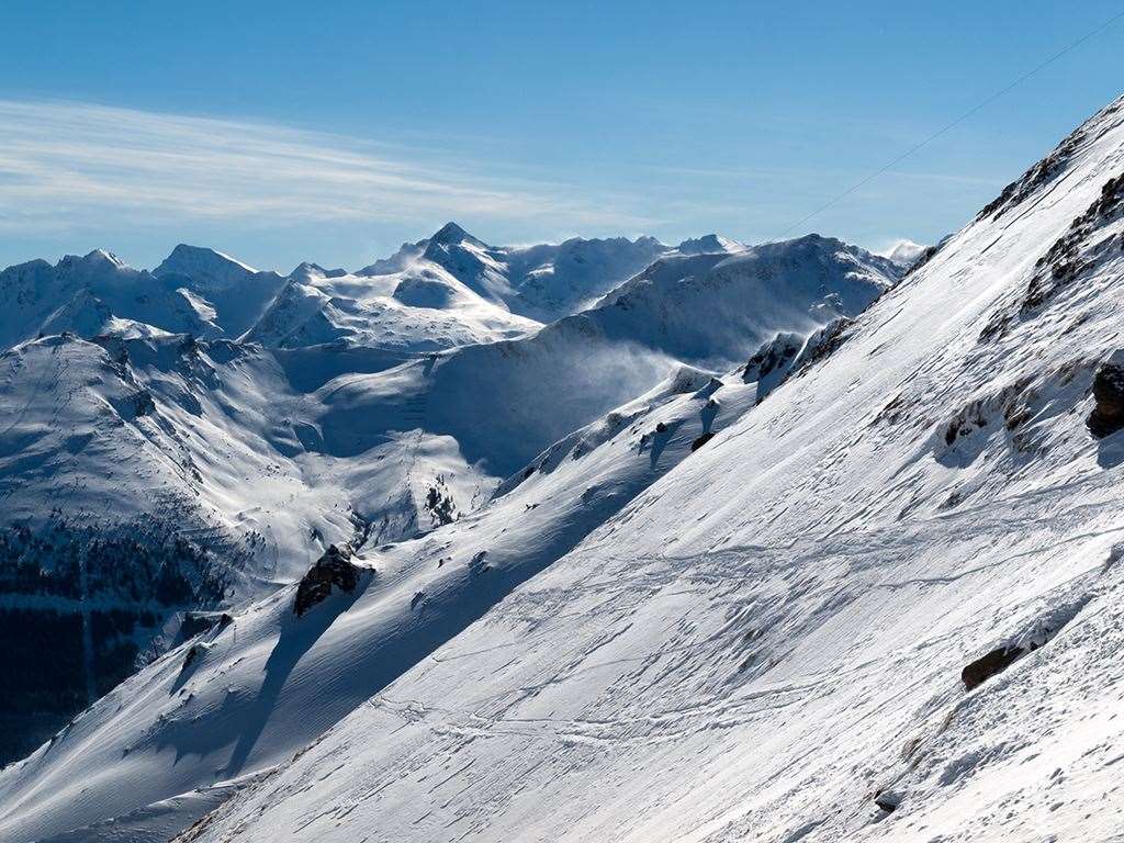 Mitteldorflift – Döllach in Austria - a snow covered mountain with snow covered mountains in the background.