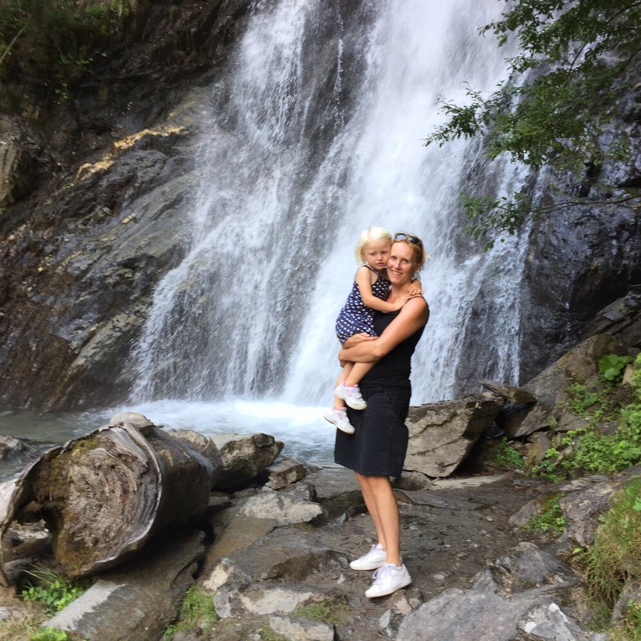 Mitteldorflift – Döllach in Austria - a woman standing in front of a waterfall.