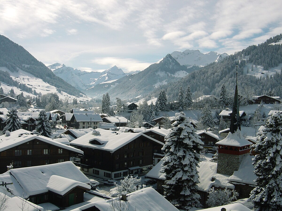 Gstaad in Switzerland - a snow covered village in the swiss alps.