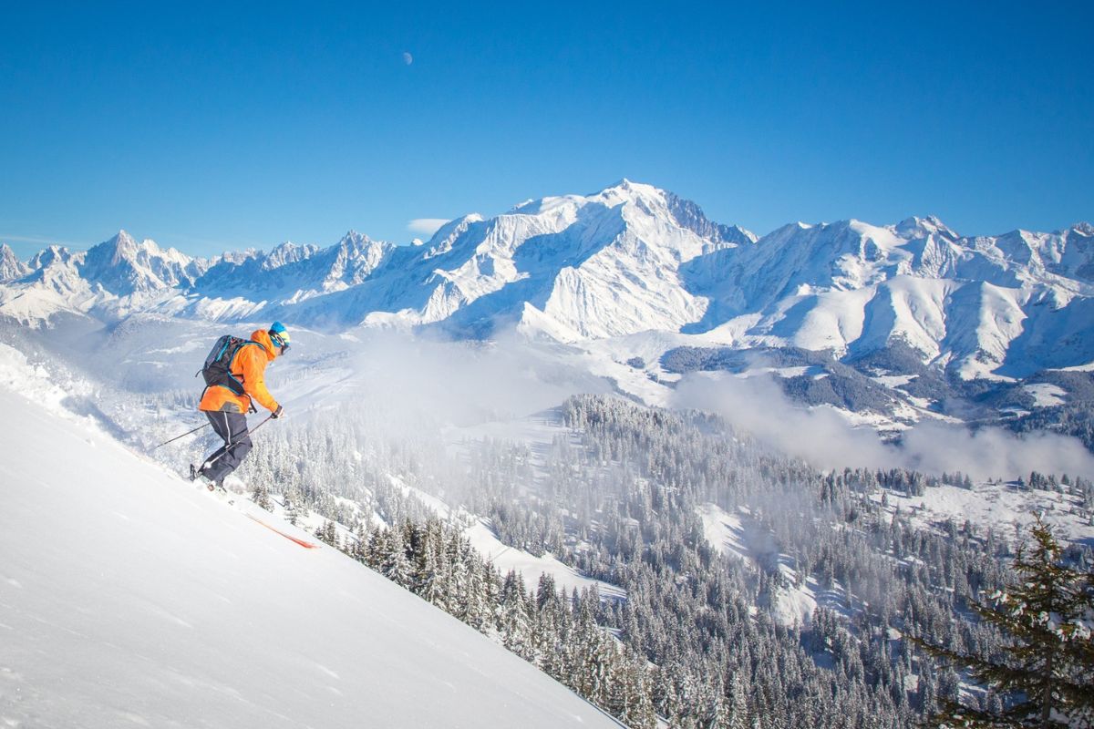 Les Portes du Mont-Blanc in France - a person skiing down a snowy slope in the mountains.