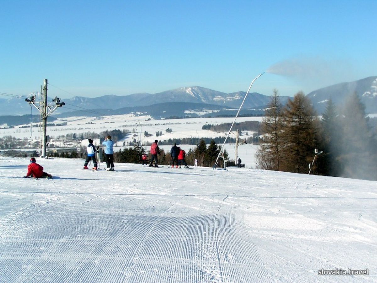 Žiar – Dolinky in Slovakia - a group of people skiing down a snowy hill.