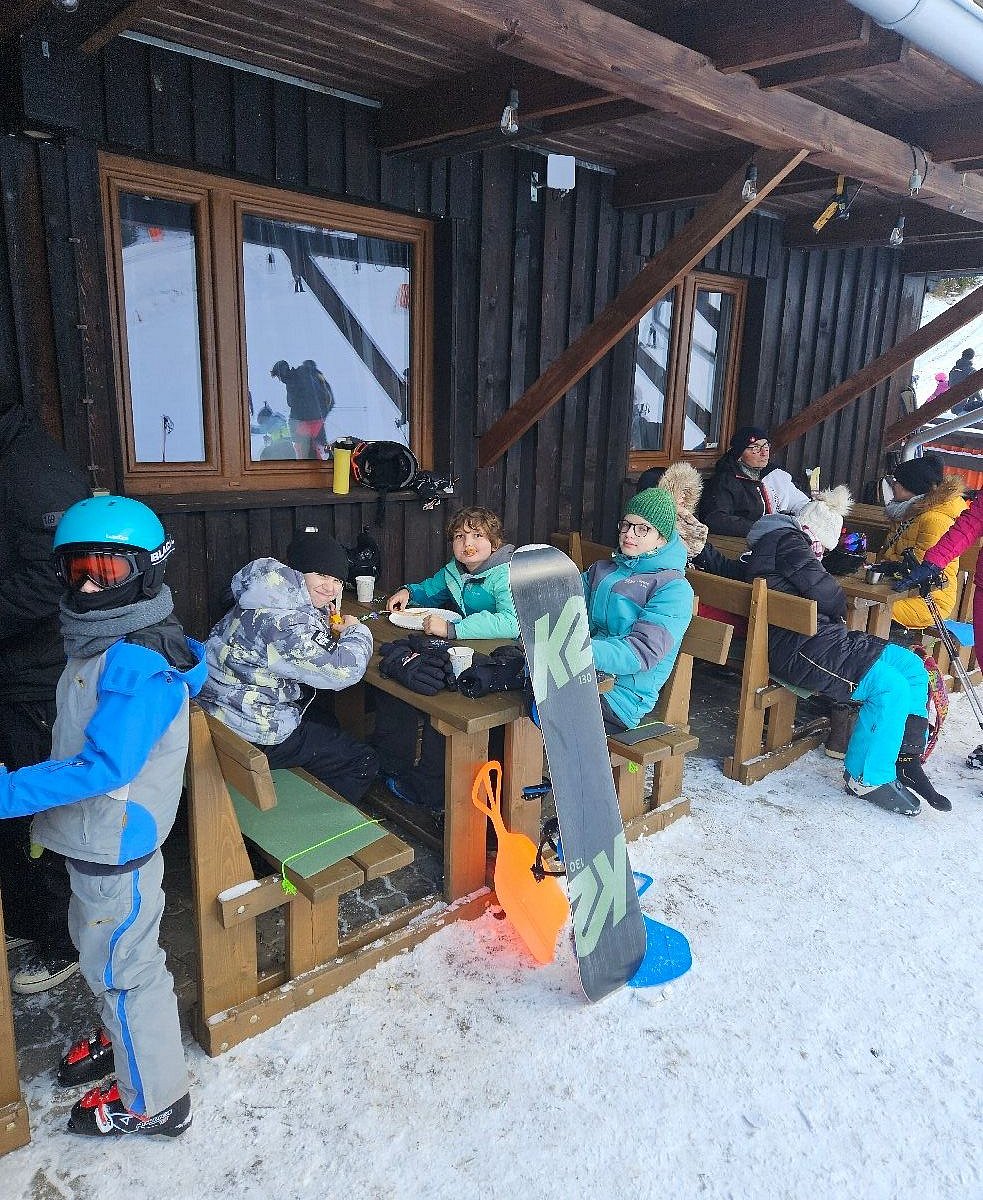 Žiar – Dolinky in Slovakia - a group of people sitting at a table in the snow.