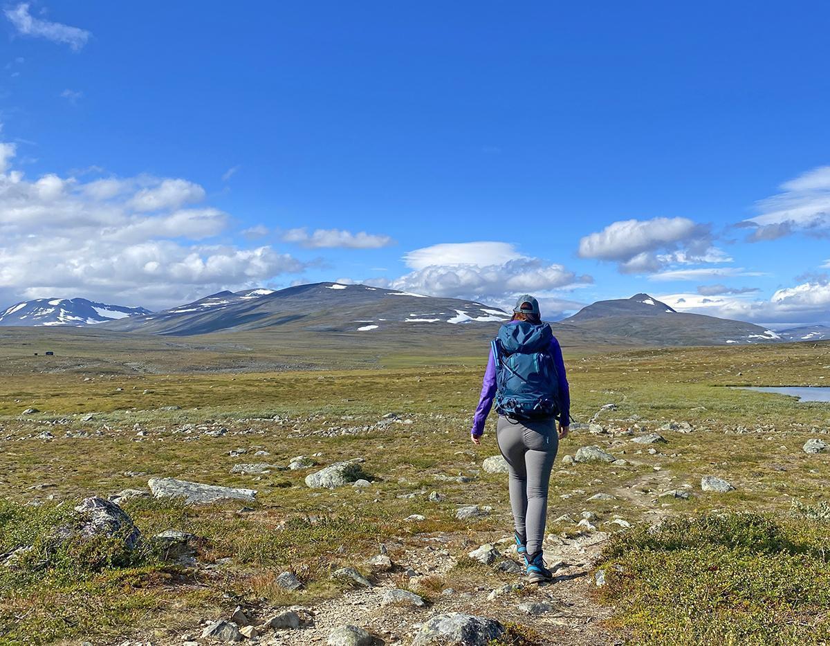 Vålådalens Fjällstation in Sweden - a person walking on a rocky trail in the mountains.