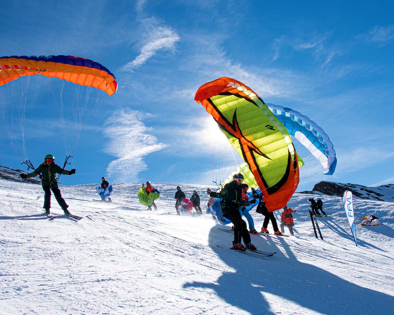 Winter scene at Valfréjus in Savoie Mont Blanc, France displaying bustling winter sports activities, a ski resort and a rustic chalet nestled in the snowy landscape.