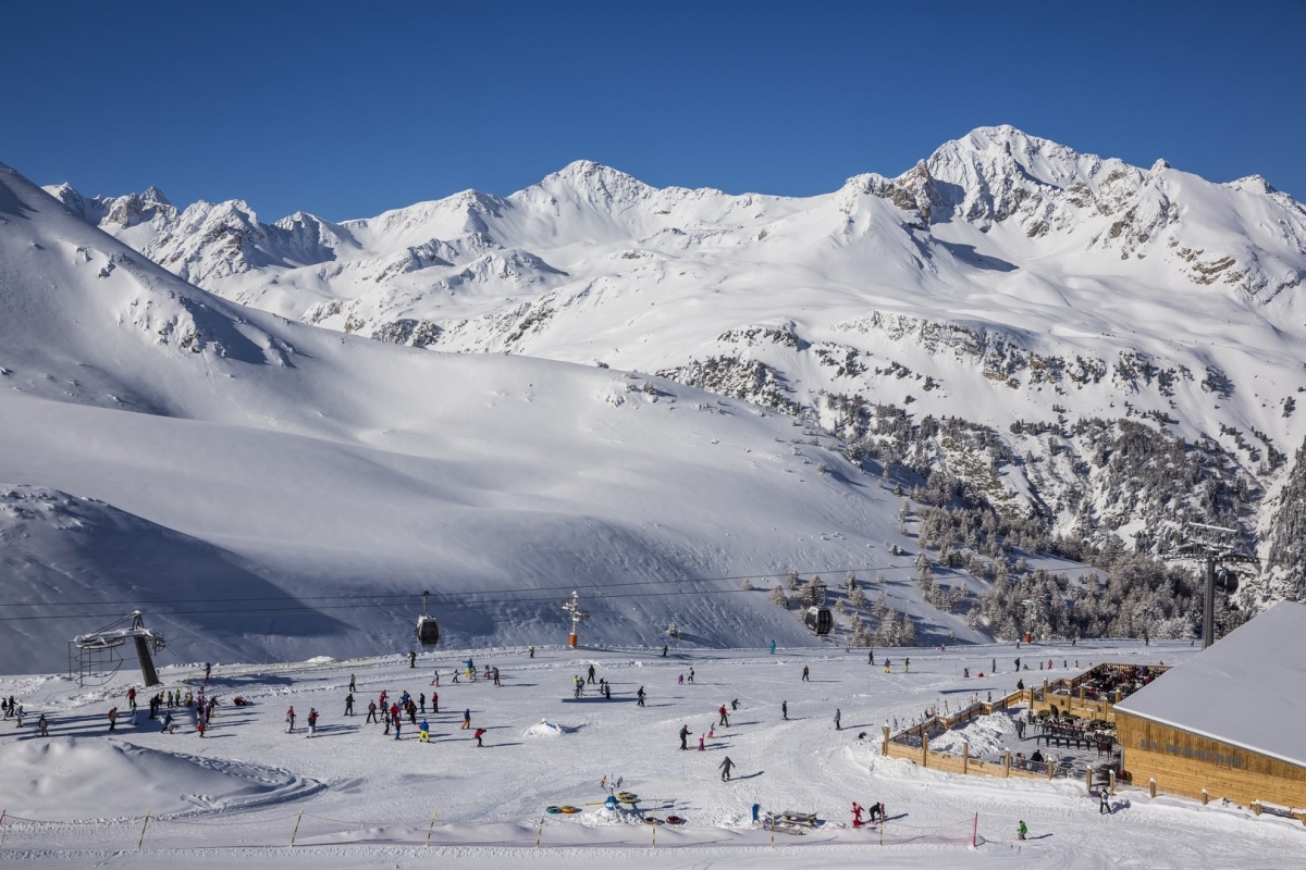 Valfréjus in France - a group of people skiing down a snowy mountain.