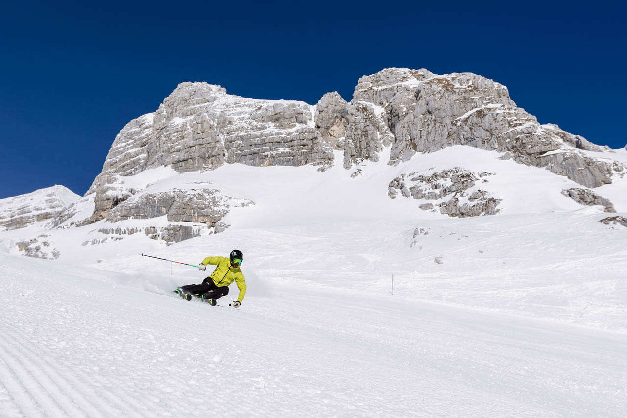 Izver – Sodražica in Slovenia - a person skiing down a snow covered mountain.